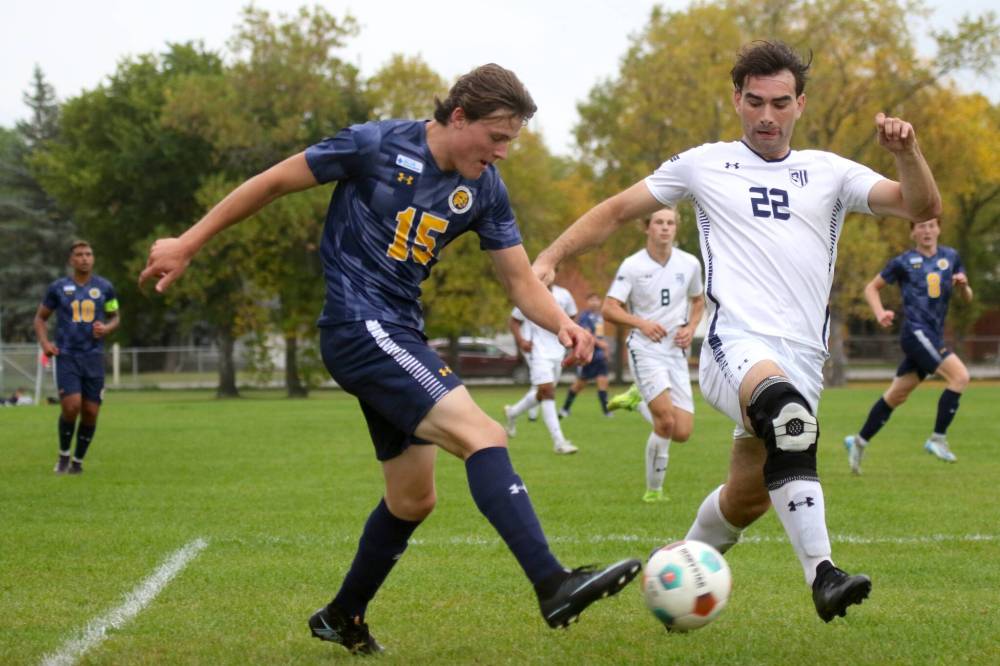 BU rookie Declan Hoad passes a ball while Providence's Christian Dyck defends. (Thomas Friesen/The Brandon Sun)