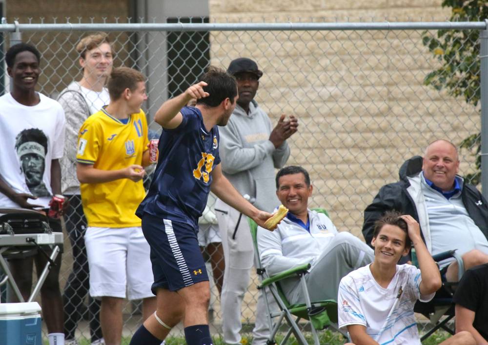 Matheus Ruffini eats a hot dog after scoring his goal on Saturday. (Thomas Friesen/The Brandon Sun)