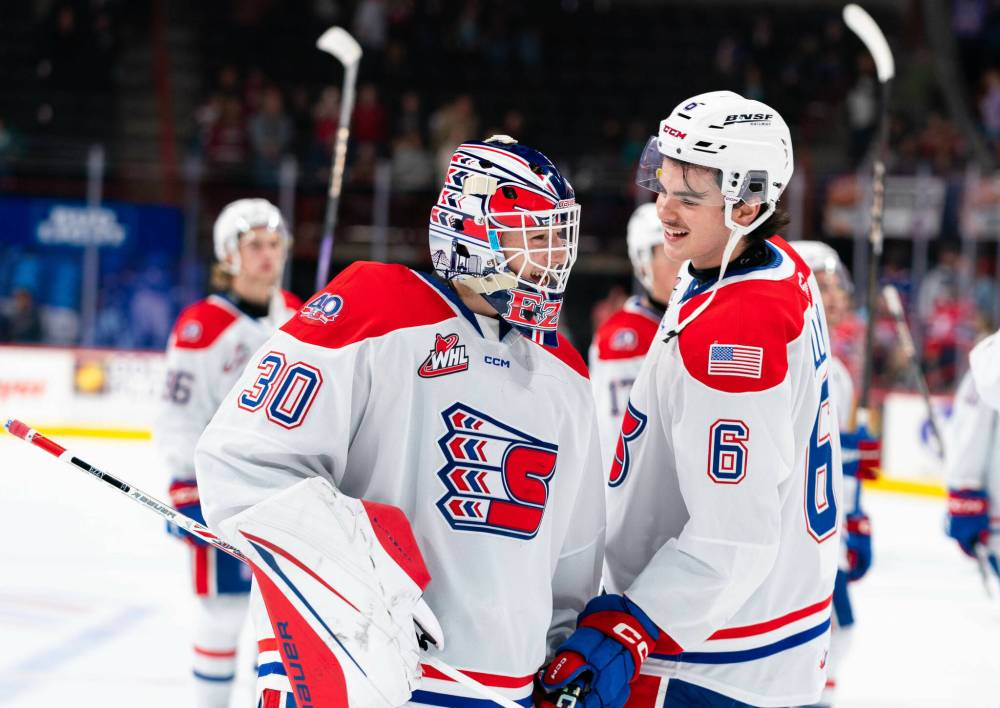 Kaden Allan (6) of Hamiota celebrates a victory with his Spokane Chiefs teammate, goalie Carter Esler. Both are back for their second seasons. (Larry Brunt/Spokane Chiefs)