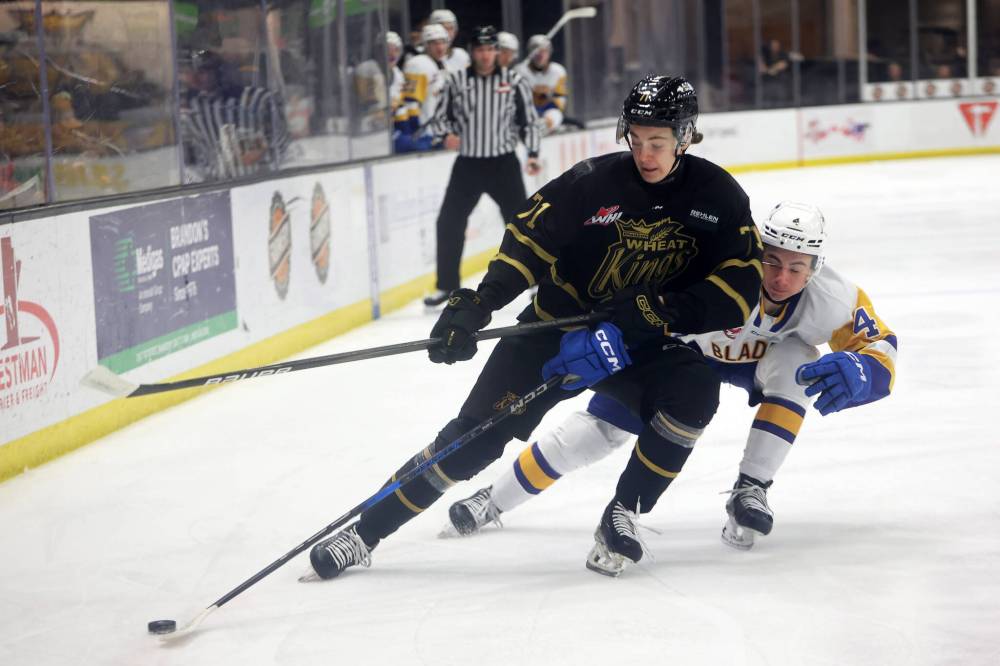 Brandon Wheat Kings forward Brady Turko (71) tries to keep the puck out of reach of Saskatoon Blades defenceman Brayden Klimpke (4). Klimpke is part of Saskatoon’s talented group of 18-year-old blue-liners. (Tim Smith/The Brandon Sun)