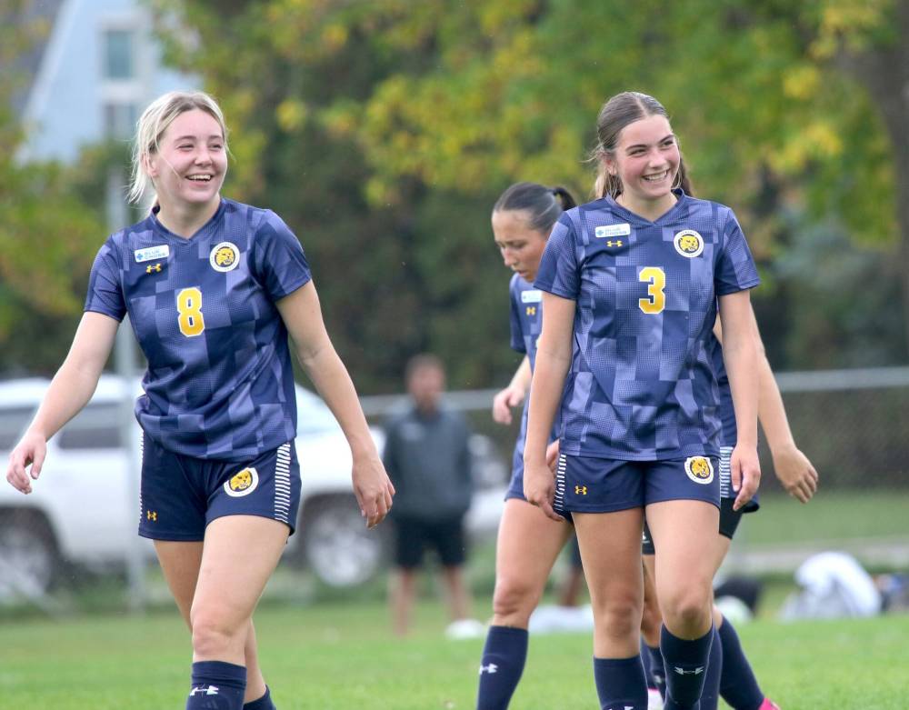 Laure Dizengremel (3) smiles with Mackenzie Boyes (8) after scoring the first goal of her Manitoba Colleges Athletic Conference career in a 4-2 Brandon University Bobcats victory over the Providence Pilots at the Healthy Living Centre field on Saturday. (Thomas Friesen/The Brandon Sun)