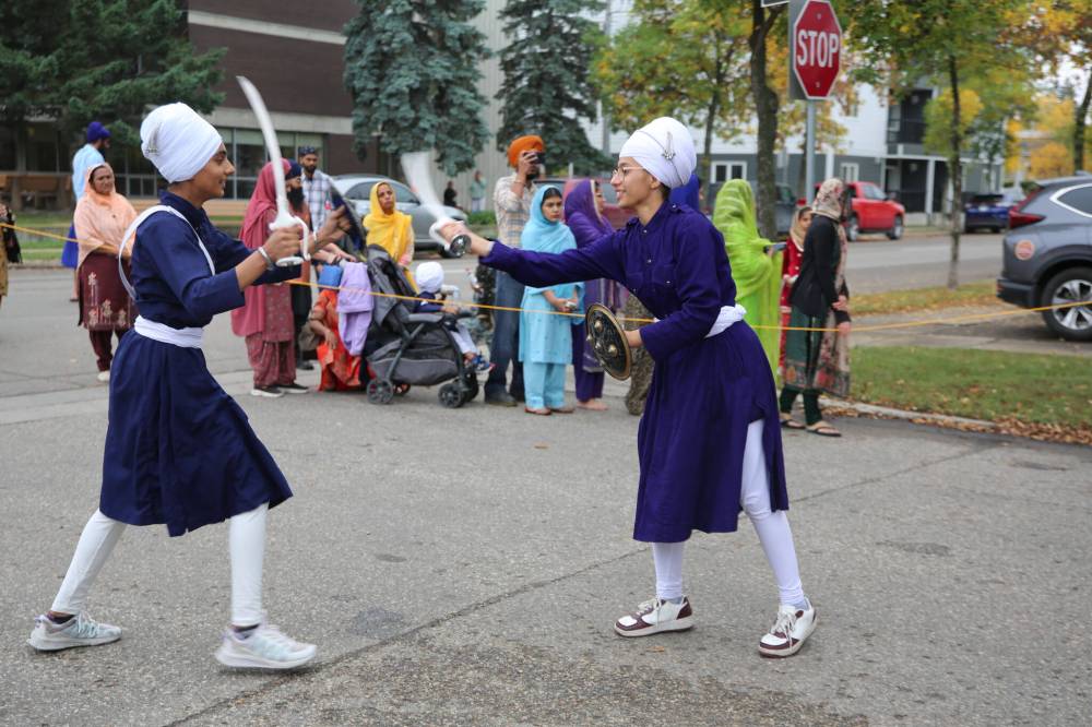 Traditional Sikh martial artists perform on 15th Street in Brandon during the procession that carried the Sikh holy scripture through Brandon’s Downtown on Sunday afternoon. (Photos by Abiola Odutola/The Brandon Sun)