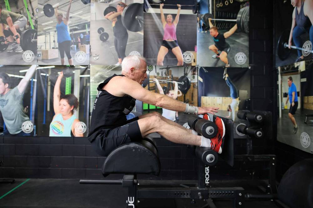 Doug Murray works through a set of GHD situps during a training class at Rocked Community Fitness in Brandon on Tuesday. (Photos by Tim Smith/The Brandon Sun)