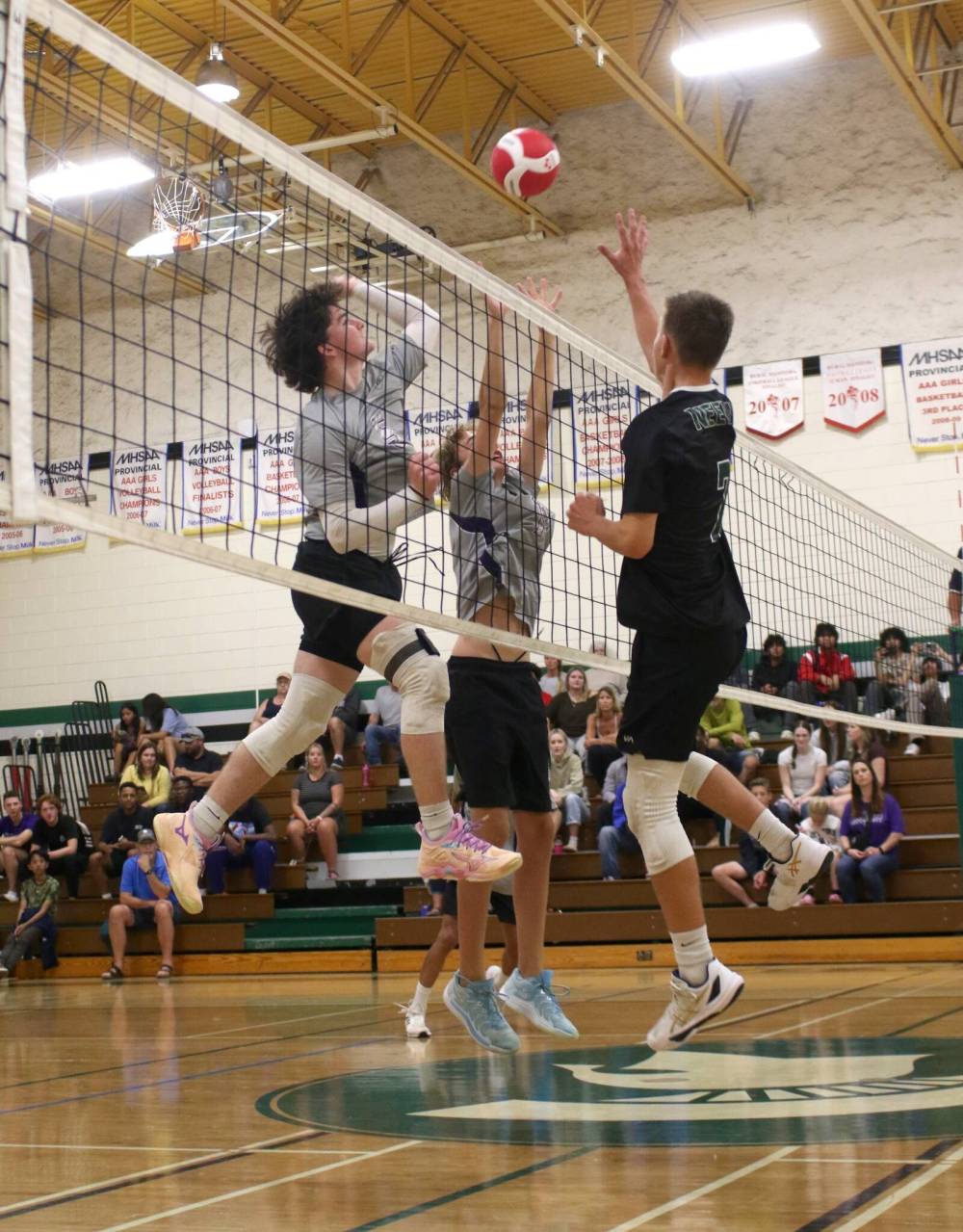 Vincent Massey’s Cohen Folkerts, left, and Alex Garrioch jump to play the ball at the net against Connor O’Greysik of the Neelin Spartans during their Brandon High School Volleyball League junior varsity boys’ match at Neelin on Wednesday. Massey won 3-1. (Thomas Friesen/The Brandon Sun)