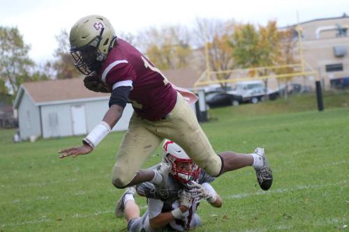 Crocus Plainsmen quarterback Joe Makori dives out of bounds against the Kelvin Clippers during their Winnipeg High School Football League game at Crocus on Thursday. (Thomas Friesen/The Brandon Sun)