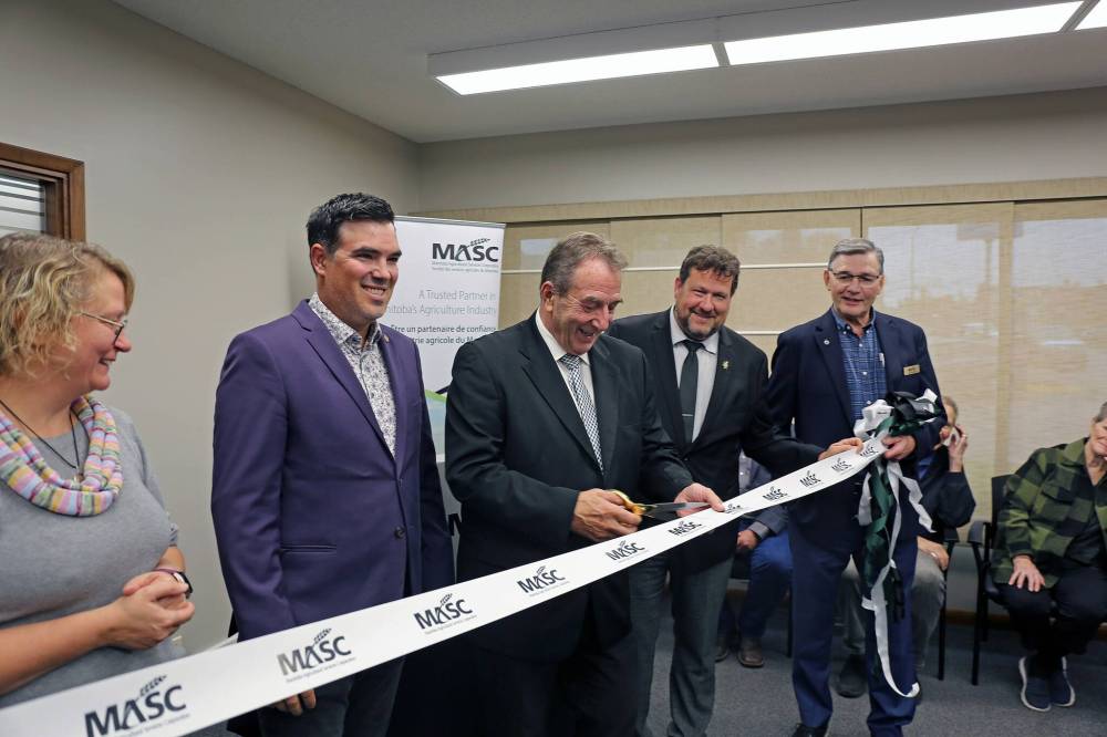 Agriculture Minister Ron Kostyshyn cuts the ribbon at Virden’s new MASC office at a grand-opening event on Friday afternoon. Mayor Tina Williams (from left), RM of Wallace-Woodworth Reeve Clayton Canart, Municipal and Northern Relations Minister Glen Simard, and MASC chair John Plohman. (Connor McDowell/The Brandon Sun)