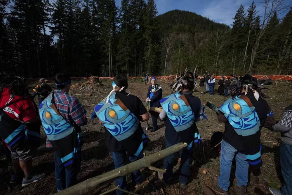 People including Adrian Dix, former B.C. health minister (middle) participate in a groundbreaking ceremony for a new Sts’ailes Nation primary health-care facility, in Harrison Mills, B.C., in March 2023. (The Canadian Press)