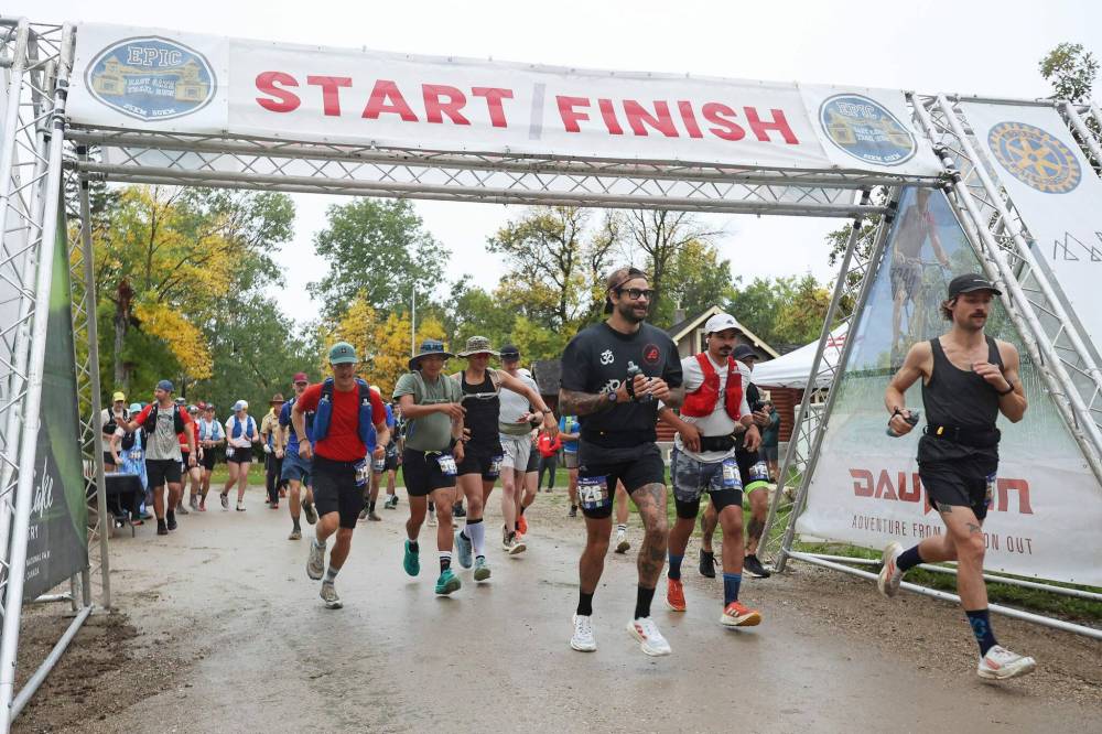 Runners in the 50-kilometre category of the Epic East Gate trail run start their run at Riding Mountain National Park’s East Gate on Saturday morning. About 165 runners entered the 50 km, 25 km or 10 km categories, braving the slippery conditions on the wet Saturday. See Page 2 for more photos. (Tim Smith/The Brandon Sun)