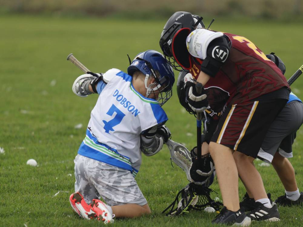 Wyatt Dobson (#7) battles to shovel the ball free for the Wranglers U11 squad. (Massimo De Luca-Taronno/The Brandon Sun)