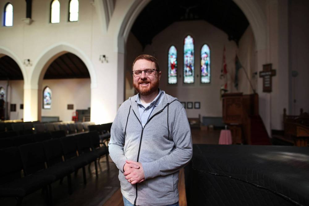 Rev. Chris Evetts, dean of St. Matthew's Anglican Cathedral in Brandon, stands inside the church on 13th Street on Tuesday. (Tim Smith/The Brandon Sun)
