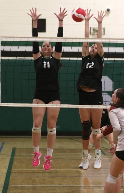 Neelin’s Layla Desjardin and Elli Pomehichuk attempt a block against the Crocus Plainsmen during Brandon High School Volleyball League varsity girls’ action at Neelin on Tuesday. (Thomas Friesen/The Brandon Sun)