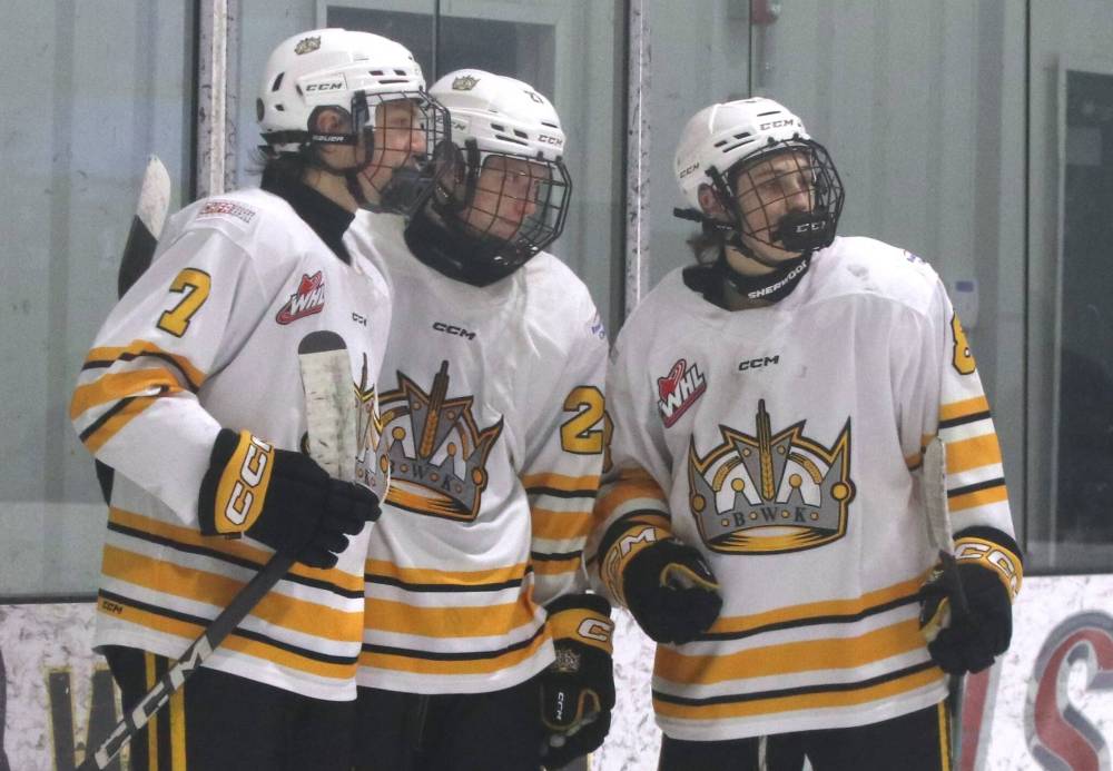 Wheat Kings forwards Reid Nicol (7), Cole Dupuis (27) and Jaxson Brick (8) celebrate a Dupuis goal last season. (Perry Bergson/The Brandon Sun)