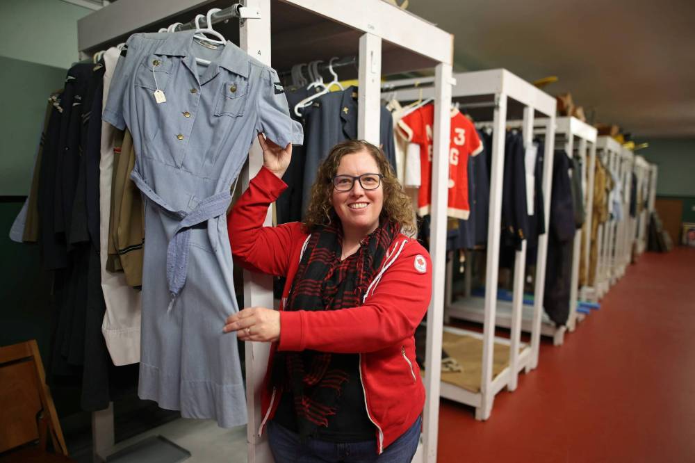 Zoe McQuinn, director general of the Commonwealth Air Training Plan Museum, holds a summer uniform from the museum archives collection of more than 50 women’s division Second World War RCAF uniforms.