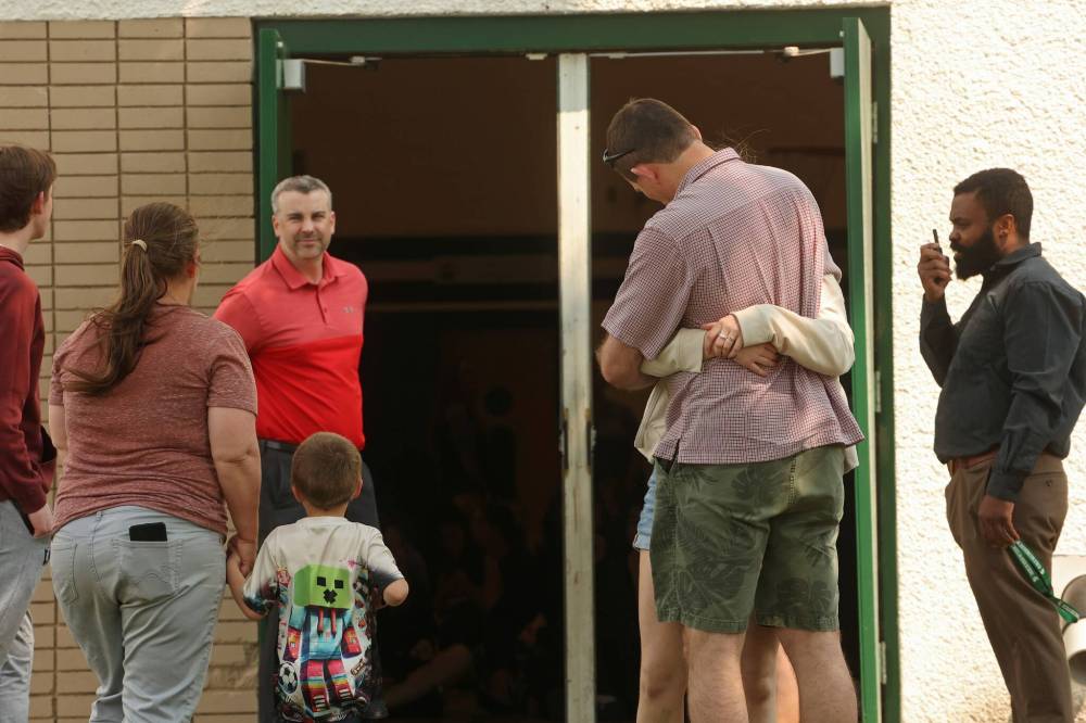 Parents and guardians wait to pick up students from École Secondaire Neelin High School’s gymnasium on June 10 after a violent attack at the school. (Tim Smith/The Brandon Sun)
