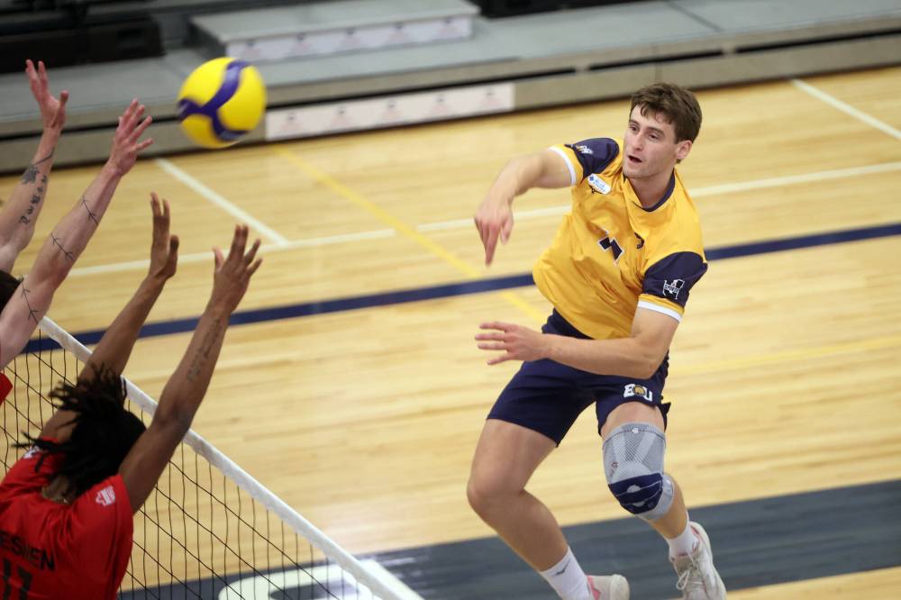 Liam Kindle of the Brandon Bobcats hammers the ball over the net during university men’s pre-season volleyball action against the University of Winnipeg Wesmen at the BU Healthy Living Centre on Friday evening. (Tim Smith/The Brandon Sun)