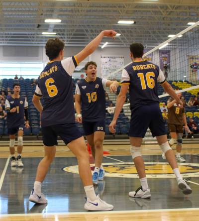 The Brandon University Bobcats celebrate a kill by Matthew Siebenga (10) during the final of their home men’s volleyball tournament against the Manitoba Bisons at the Healthy Living Centre on Sunday. (Thomas Friesen/The Brandon Sun)