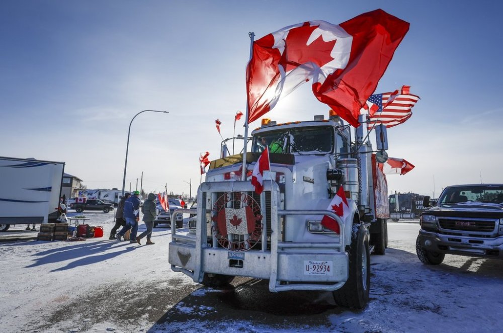 A truck adorned with Canadian and American flags is shown at the blockade at the United States border at Coutts, Alta., Wednesday, Feb. 2, 2022. THE CANADIAN PRESS/Jeff McIntosh