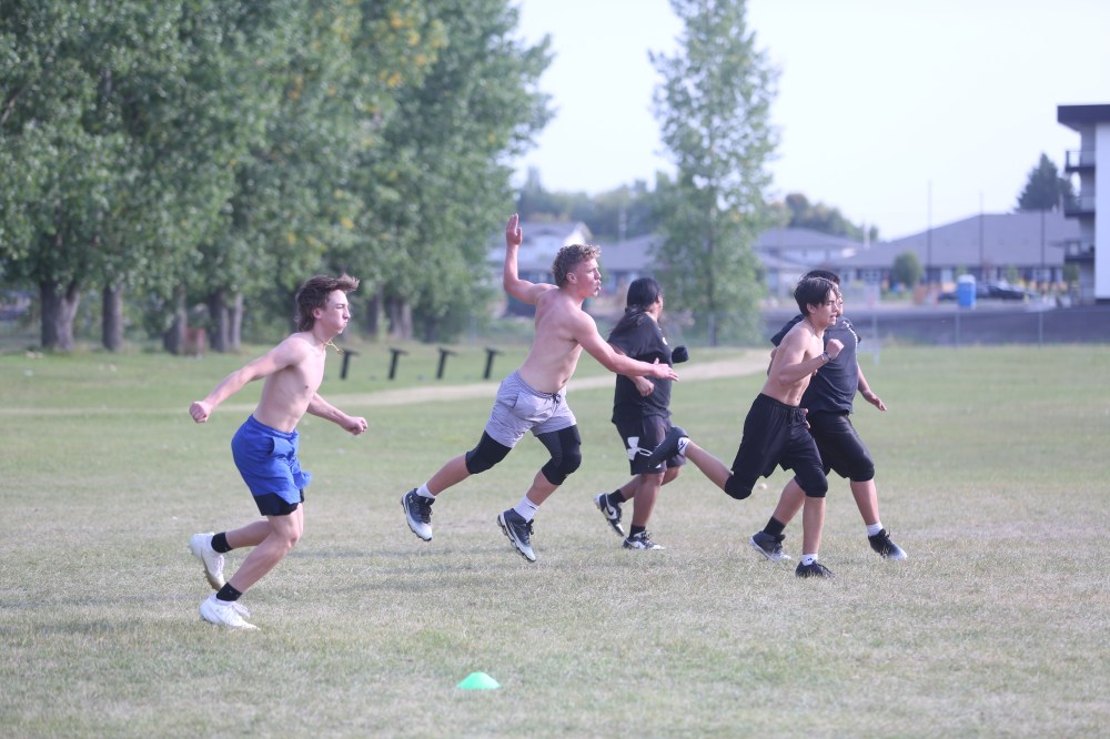 Crocus Plains Plainsmen varsity players work out on the practice field on Monday afternoon ahead of their Thursday matchup against the Steinbach Sabres. (Abiola Odutola/The Brandon Sun)