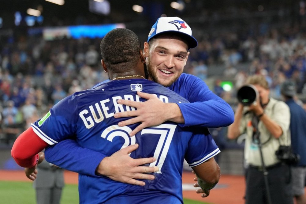 Blue Jays pitcher Trey Yesavage (39) and teammate Vladimir Guerrero Jr. (27) celebrate following their 13-7 win over the New York Yankees in MLB American League Division Series action in Toronto on Oct. 5, 2025. THE CANADIAN PRESS/Nathan Denette