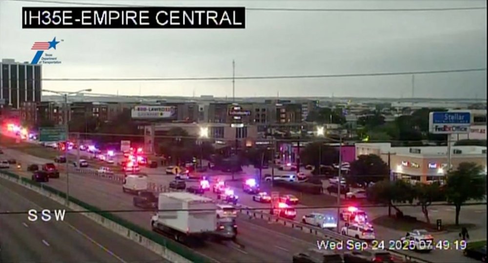 This traffic camera image shows heavy police presence off I-35E close to a U.S. Immigration and Customs Enforcement office, in northwest Dallas on Thursday, Sept. 24, 2025. (WFAA via AP)