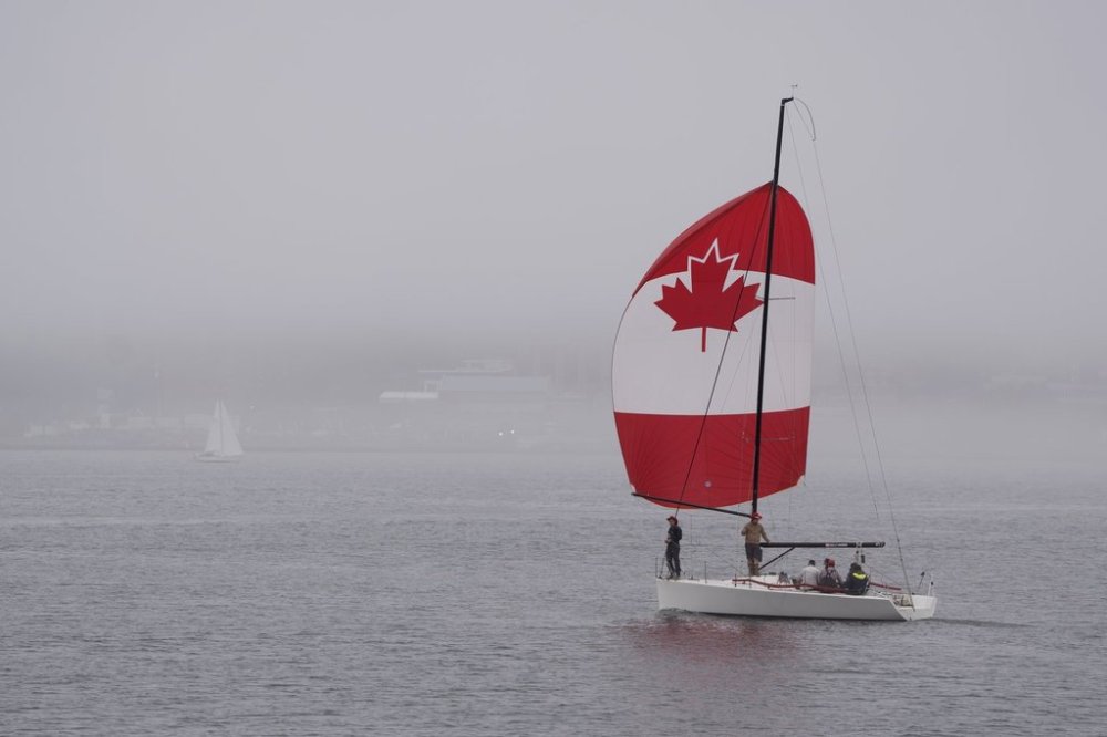 A sailboat with a Canada flag-themed sail is seen in Halifax Harbour during Canada Day festivities in Halifax on Saturday, July 1, 2023. THE CANADIAN PRESS/Darren Calabrese