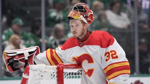 Calgary Flames goaltender Dustin Wolf (32) during the first period of an NHL hockey game against the Dallas Stars Sunday, Dec. 8, 2024, in Dallas. (AP Photo/LM Otero)