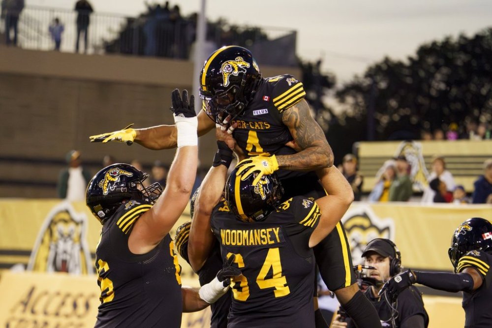 Hamilton Tiger Cats wide receiver Brendan O'Leary-Orange (4) celebrates with teammates during first quarter CFL football game action against the Edmonton Elks in Hamilton, Ont., Saturday, Sept. 20, 2025. THE CANADIAN PRESS/Peter Power
