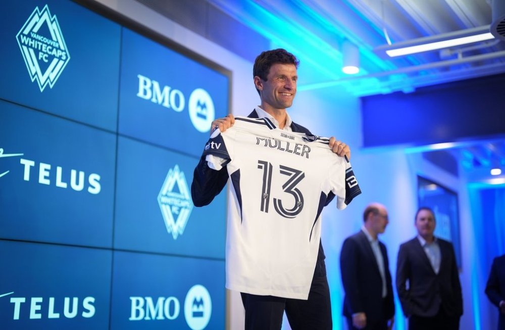 New Vancouver Whitecaps player Thomas Muller poses with his jersey during a news conference in Vancouver, on Thursday, Aug. 14, 2025. The MLS soccer club signed the 2014 World Cup champion and longtime Bayern Munich star to their roster last week in a deal that also includes a designated player option for the 2026 campaign. THE CANADIAN PRESS/Darryl Dyck