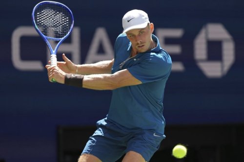 Denis Shapovalov, of Canada, returns a shot against Jannik Sinner, of Italy, during the third round of the U.S. Open tennis championships, Saturday, Aug. 30, 2025, in New York. (AP Photo/Kirsty Wigglesworth)