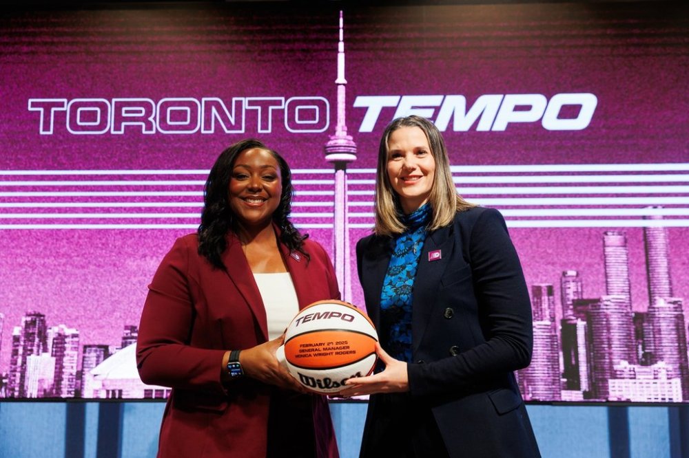 Newly named general manager Monica Wright Rogers (left) and Teresa Resch, president of the Toronto Tempo, pose with a basketball at a WNBA Toronto Tempo team announcement in Toronto, Thursday, Feb. 20, 2025. THE CANADIAN PRESS/Cole Burston