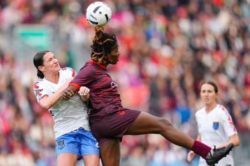 Montreal Roses FC Defender Lucy Cappadona (left) and AFC Toronto forward Esther Okoronkwo (23) jump for the ball during second half Northern Super League soccer action in Toronto on Saturday, April 19, 2025. THE CANADIAN PRESS/Arlyn McAdorey