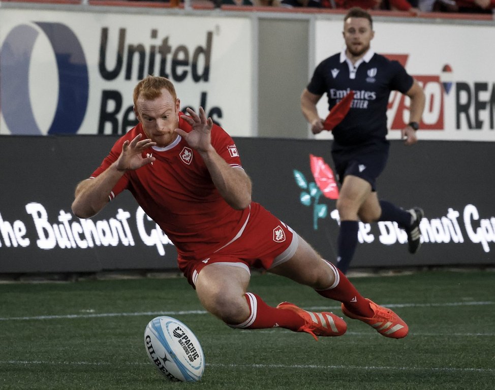 Canada's Peter Nelson dives on the ball to score a try during second half Pacific Nations Cup rugby action against the United States in Calgary, Alta., on Friday, Aug. 22, 2025. THE CANADIAN PRESS/Jeff McIntosh