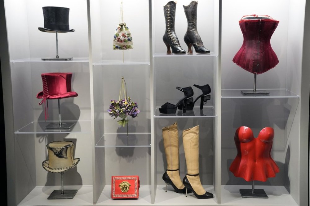 Various fashion pieces are displayed during a press preview for the exhibit