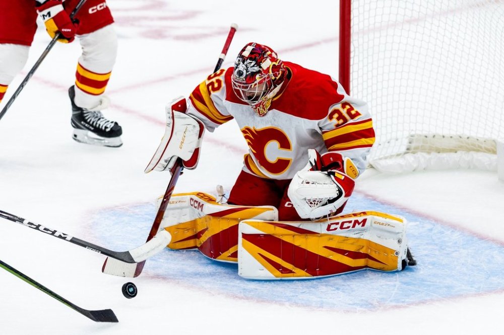 Calgary Flames goaltender Dustin Wolf makes a save during the first period of an NHL hockey game against the Seattle Kraken, Monday, Sept. 29, 2025, in Seattle. (AP Photo/Maddy Grassy)