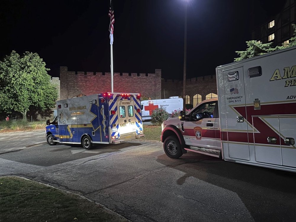 Ambulances are parked outside a hotel that is acting as a reunification center after a shooting at a country club in Nashua, New Hampshire, Saturday, Sept. 20, 2025. (AP Photo/Michael Casey)
