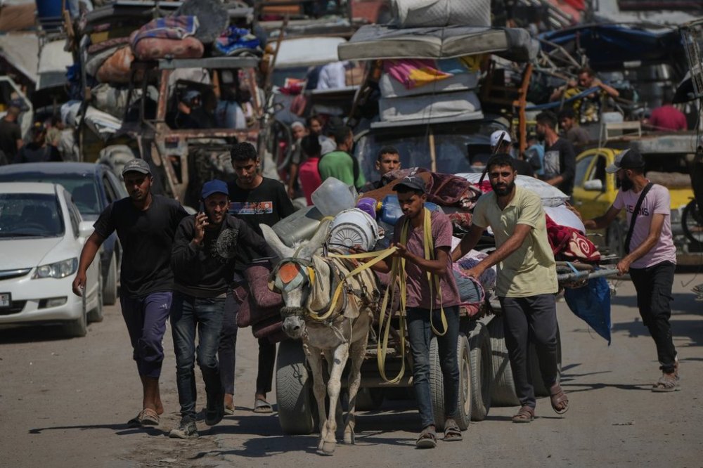 Displaced Palestinians flee northern Gaza Strip as they walk carrying their belongings along the coastal road, near Wadi Gaza, Wednesday, Sept. 24, 2025. (AP Photo/Abdel Kareem Hana)