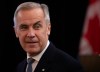 Prime Minister Mark Carney greets party members as he arrives to deliver remarks at the Liberal caucus in Edmonton on Wednesday September 10, 2025.  THE CANADIAN PRESS/Amber Bracken