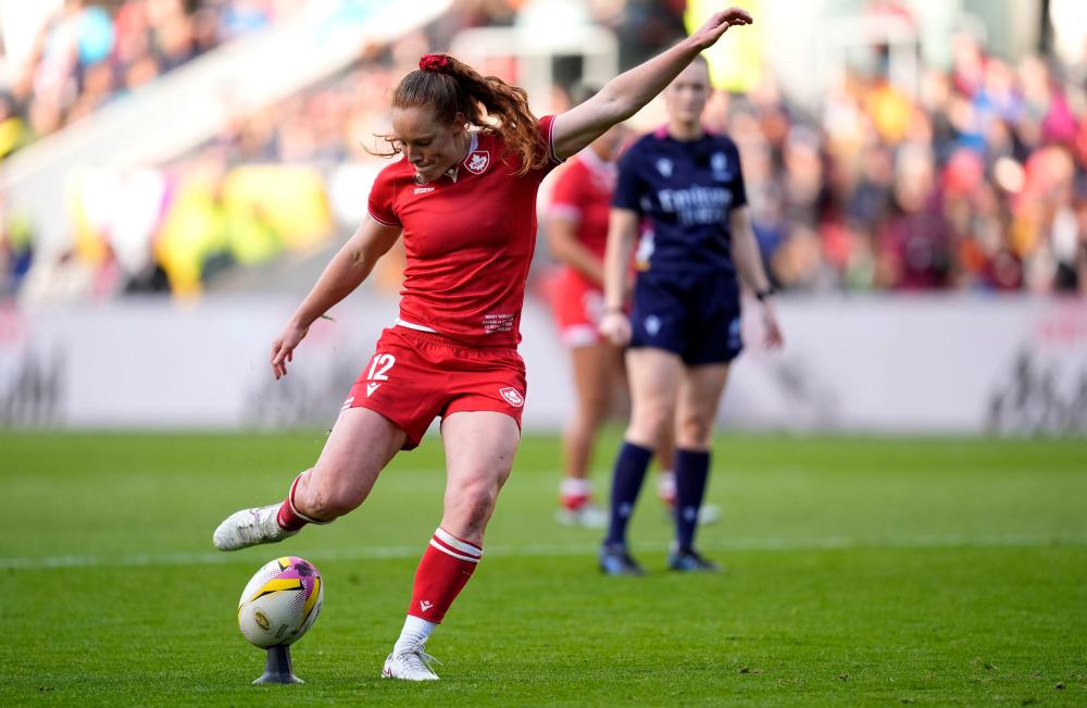 Canada's Alex Tessier kicks a penalty against Australia's Caitlyn Halse during the Women's Rugby World Cup quarterfinal match on Saturday at Ashton Gate, Bristol, England. A commission recently identified the need for widespread change in Canada's systems for sports, but columnists write that change will be difficult. (Andrew Matthews/PA via The Associated Press)