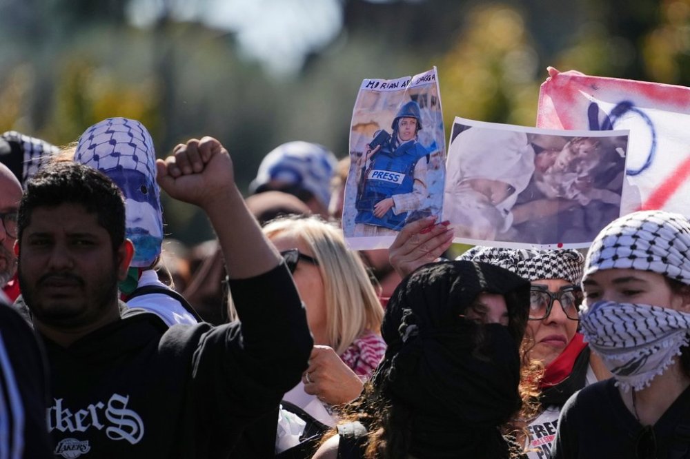 Pro Palestinian demonstrators hold up a photograph of Mariam Dagga, a visual journalist who freelanced for The Associated Press, killed in an Israeli strike in August, as they march during a national demonstration in support of the population of Gaza, in Rome, Saturday, Oct. 4, 2025. (AP Photo/Alessandra Tarantino)