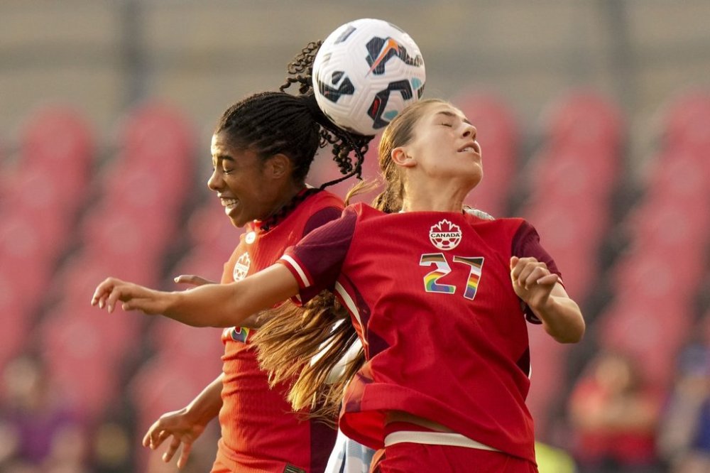 Canada's Holly Ward (27) and Ashley Lawrence compete for a header during first half international women's friendly soccer action against Costa Rica in Toronto, on Friday June 27, 2025. THE CANADIAN PRESS/Chris Young