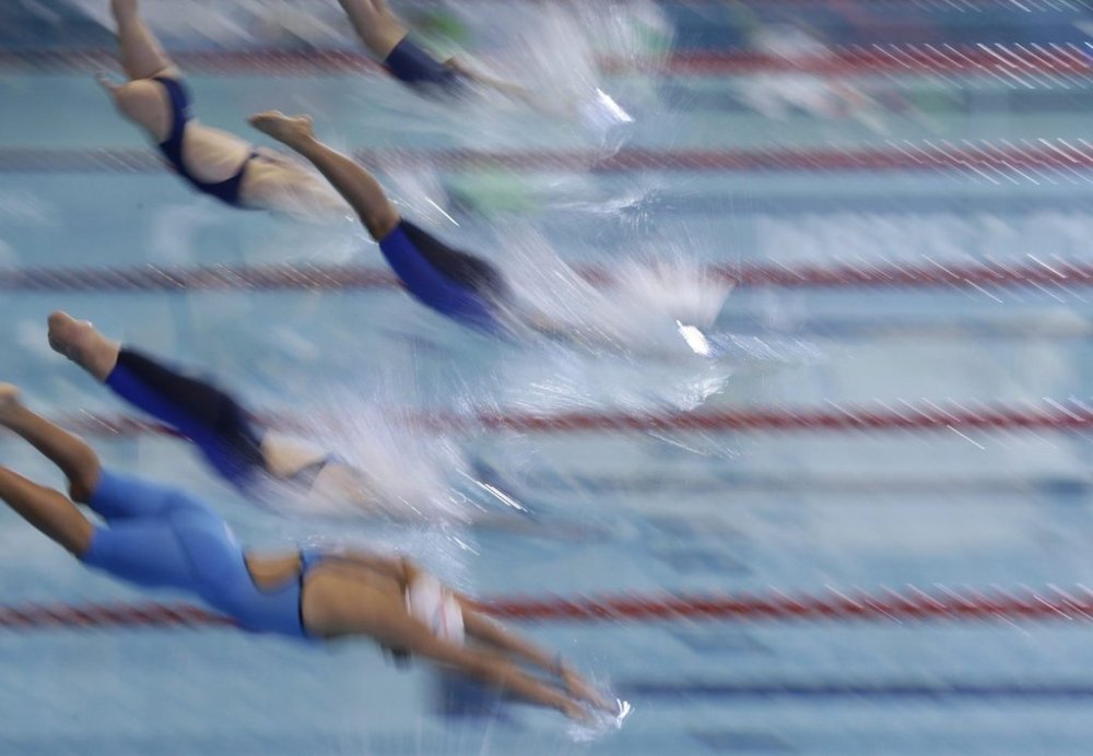 Competitors dive from the starting blocks in the women's 100-meter freestyle S8 final at the World Para Swimming Championships in Mexico City, Sunday, Dec. 3, 2017. The World Para Swimming and Para Powerlifting championships are taking place in Mexico's capital through Dec. 8. (AP Photo/Rebecca Blackwell)