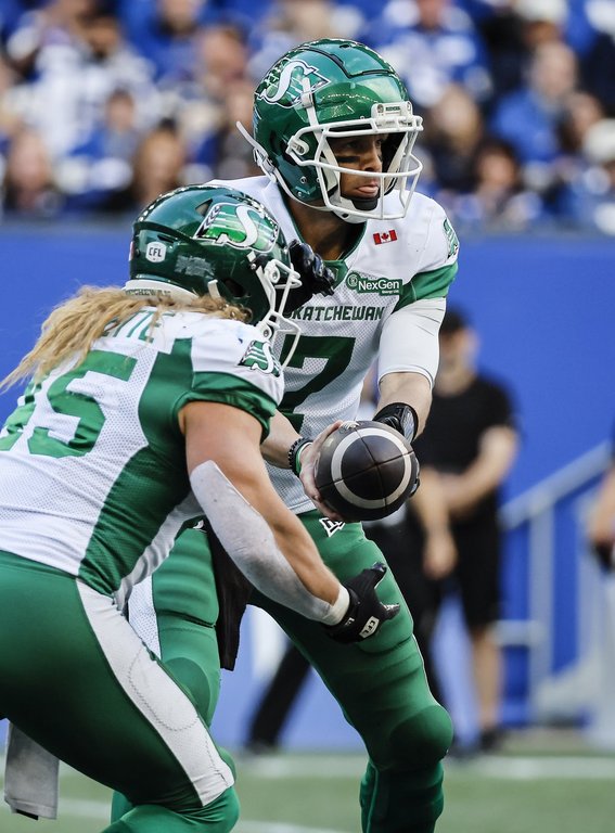 Saskatchewan Roughriders quarterback Trevor Harris (7) hands off to AJ Ouellette (45) during second half CFL action against the Winnipeg Blue Bombers in Winnipeg, Saturday, Sept. 6, 2025. THE CANADIAN PRESS/John Woods