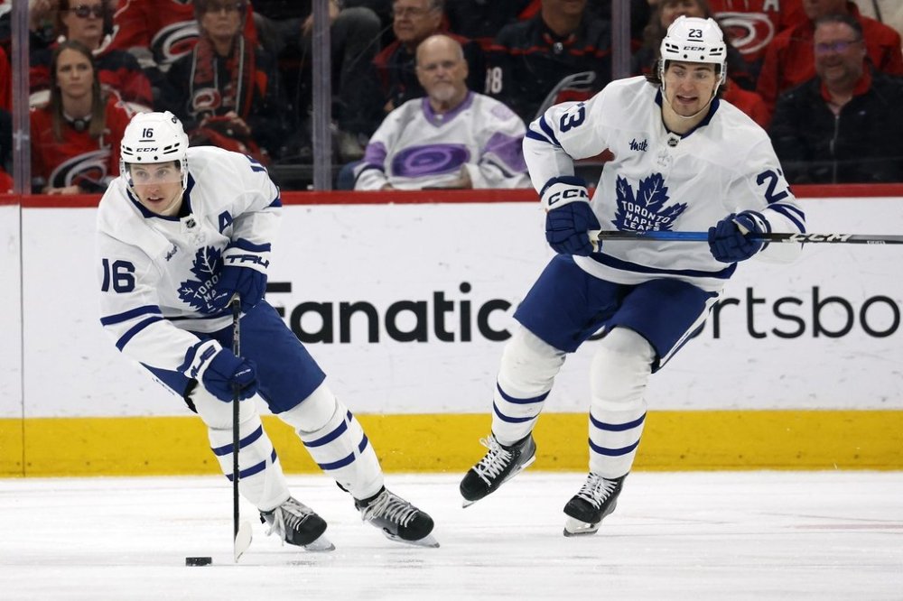 Former Toronto Maple Leafs winger Mitch Marner (16) and ex-teammate Matthew Knies (23) during the first period of an NHL hockey game against the Carolina Hurricanes in Raleigh, N.C., on Sunday, April 13, 2025. (AP Photo/Karl DeBlaker)