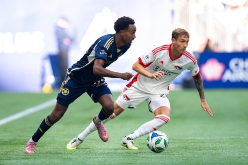 Vancouver Whitecaps' Ali Ahmed (22) and San Jose Earthquakes' Benji Kikanovic, right, vie for the ball during the first half of an MLS soccer match in Vancouver, on Sunday, October 5, 2025. THE CANADIAN PRESS/Ethan Cairns