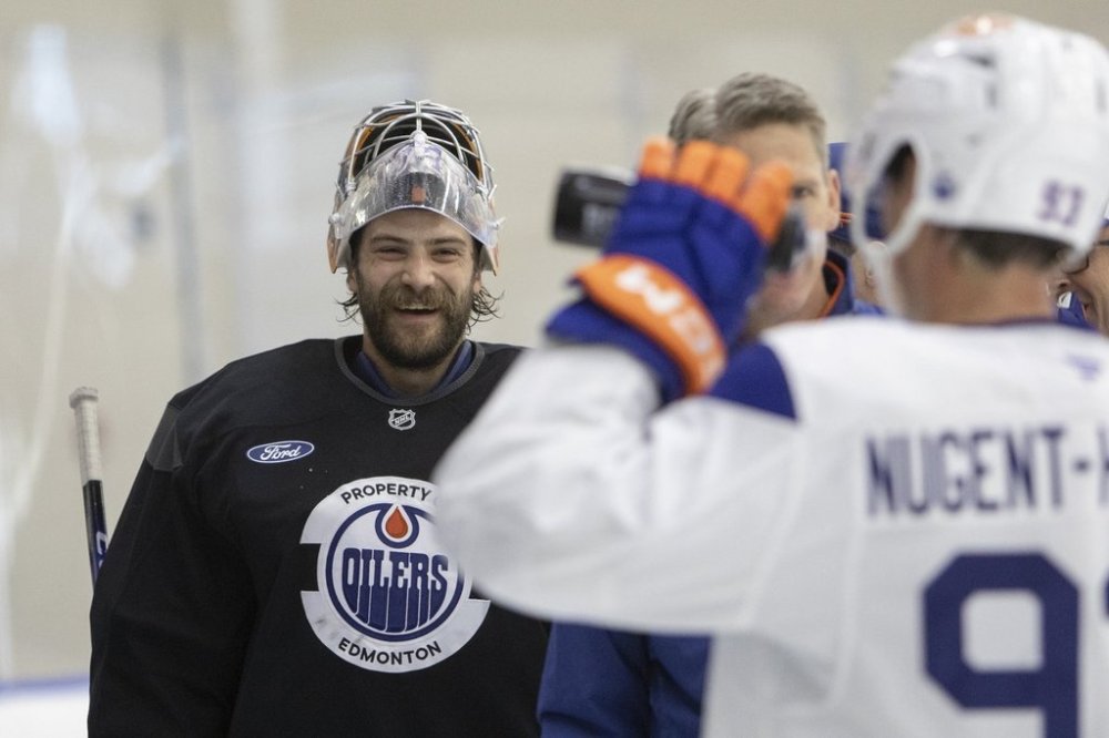 Oilers goalie Stuart Skinner (74) laughs with teammates during training camp in Edmonton on Thursday, Sept. 18, 2025. THE CANADIAN PRESS/Amber Bracken