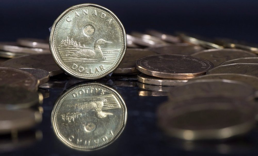 The Canadian dollar coin, the Loonie, is displayed on Friday, Jan. 30, 2015, in Montreal. THE CANADIAN PRESS/Paul Chiasson