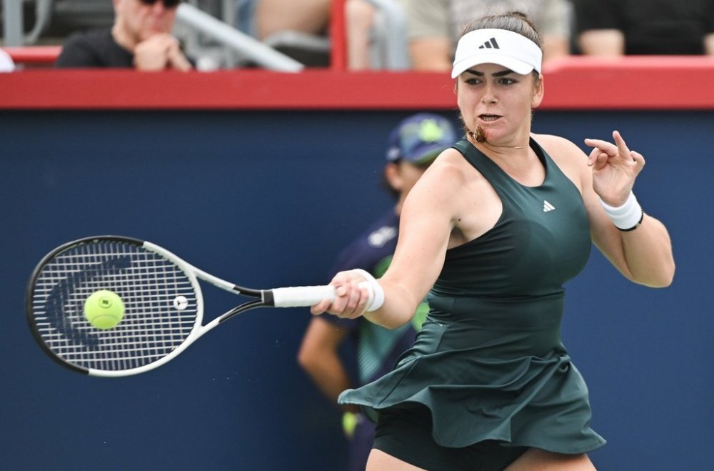 Marina Stakusic, of Canada, plays a shot to Jaqueline Cristian, of Romania, during their first round match at the National Bank Open tennis tournament in Montreal, Sunday, July 27, 2025. THE CANADIAN PRESS/Graham Hughes
