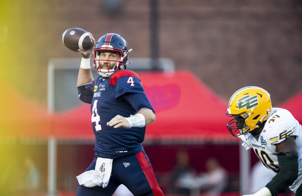 Montreal Alouettes quarterback McLeod Bethel-Thompson (4) throws ball under pressure from Edmonton Elks' Robbie Smith (40), during first half CFL action in Montreal on Friday, Aug. 8, 2025. THE CANADIAN PRESS/Christopher Katsarov