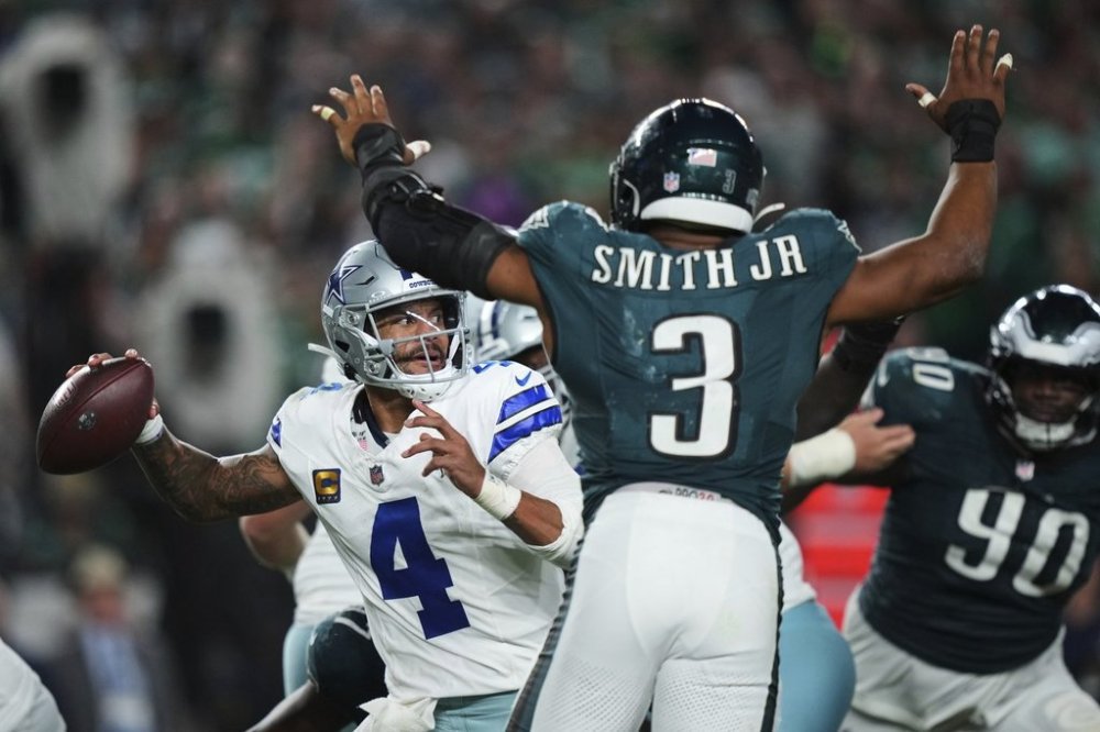 Dallas Cowboys quarterback Dak Prescott (4) throws a pass under pressure from Philadelphia Eagles linebacker Nolan Smith Jr. (3) in the second half of an NFL football game Friday, Sept. 5, 2025, in Philadelphia. (AP Photo/Matt Slocum)