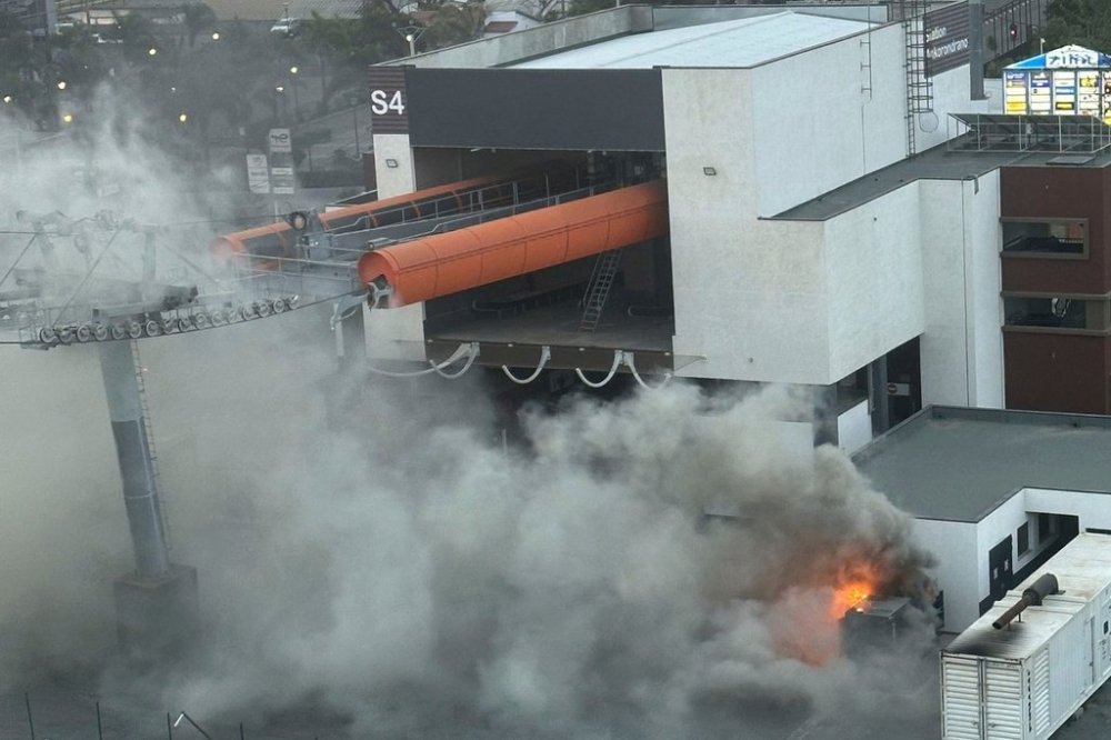 Protesters set fire to a newly built cable car station, which only operates for three hours a day, powered by a generator due to a lack of electricity in the capital, in Antananarivo, Madagascar, Thursday, Sept. 25, 2025. (AP Photo/Sarah Tetaud)